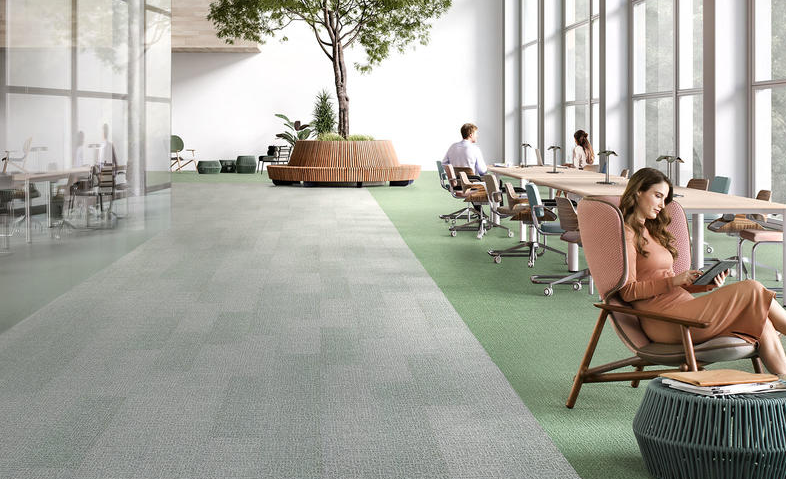 Une image de moquette avec des tons de gris et de vert dans un espace de coworking. Une image de moquette avec des tons de gris et de vert dans un espace de coworking.